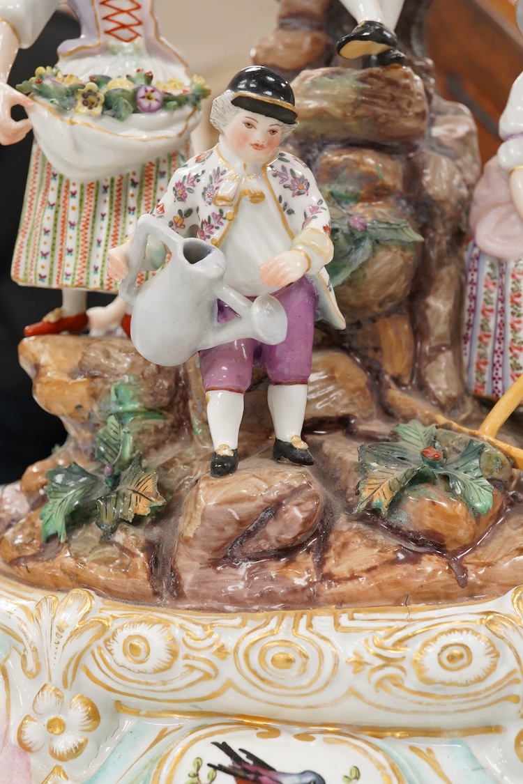 A pair of German porcelain figure groups, late 19th century and a Dresden centrepiece bowl-29cm high